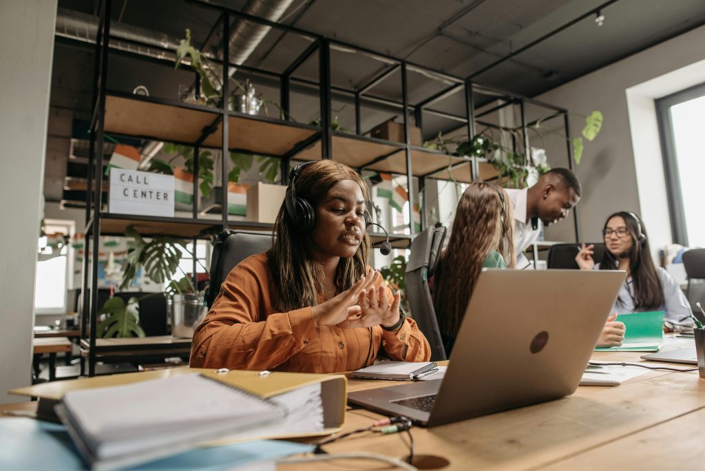 Diverse call center team working collaboratively in a modern office environment.