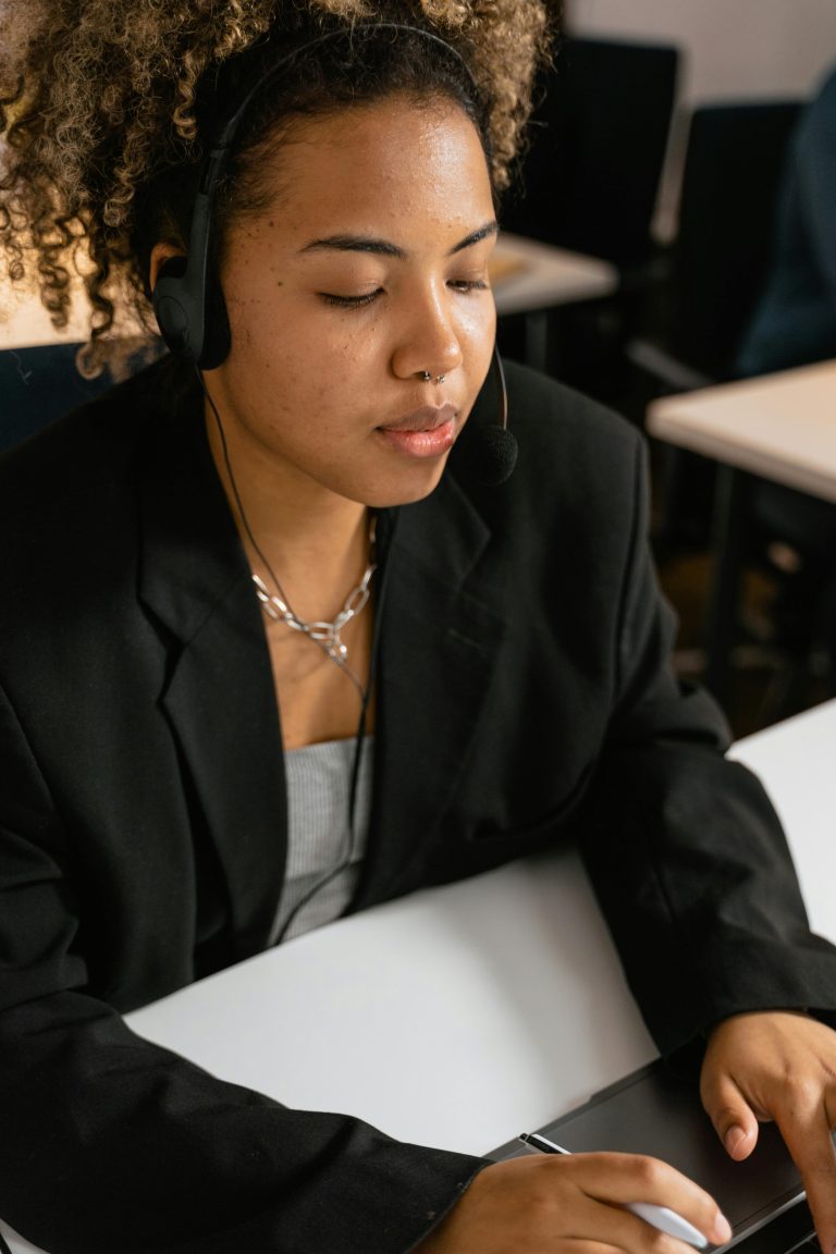 Professional woman working in a call center with a headset, providing customer support.