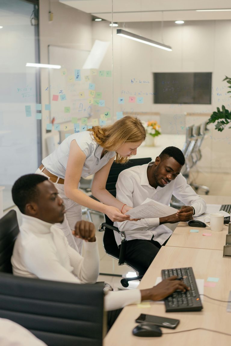 Multicultural team engaged in collaborative work session in a modern office environment.